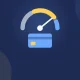 Illustration of a credit score gauge with its needle pointing high above a blue credit card.