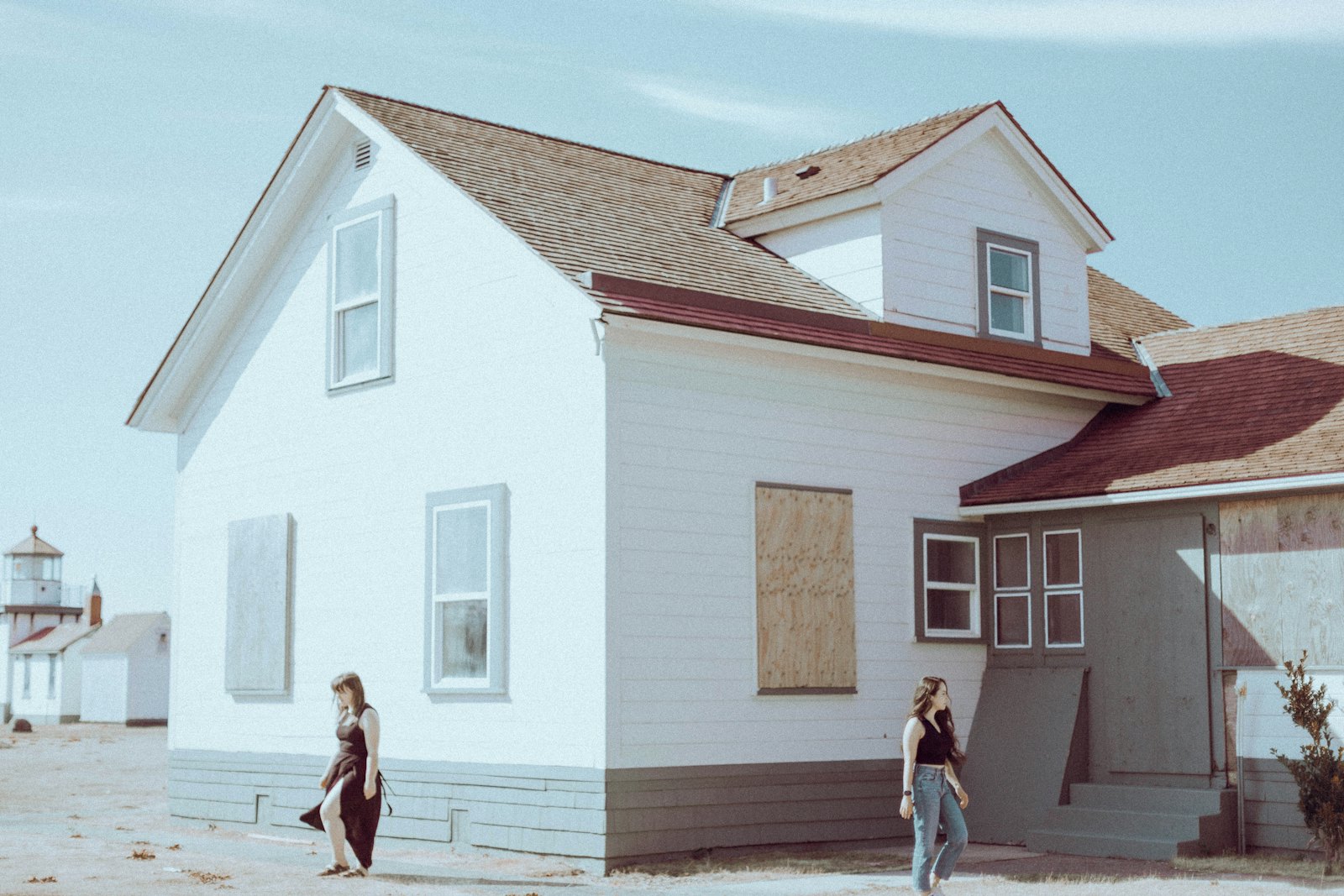 Two people walking together in front of a suburban house